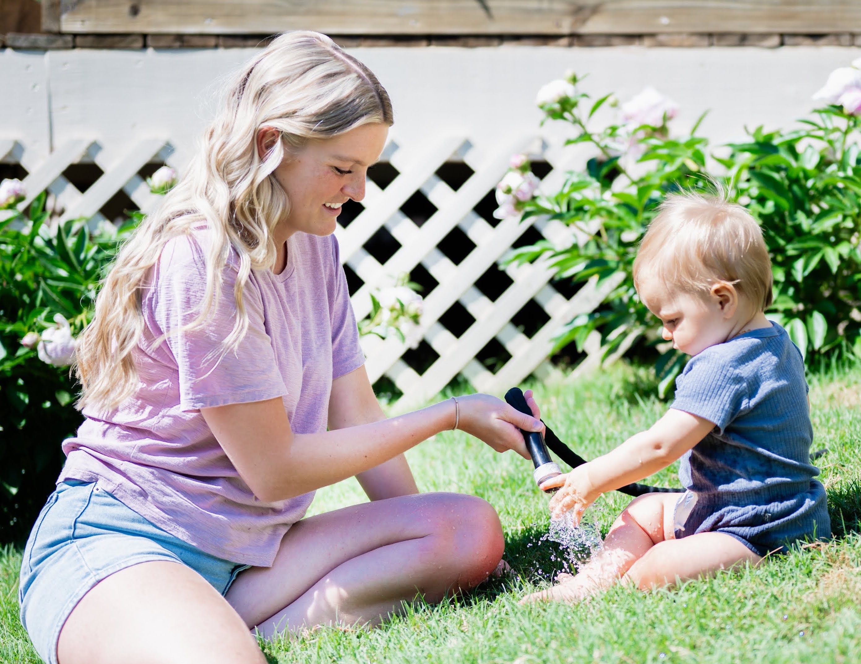Mom and child using the hose