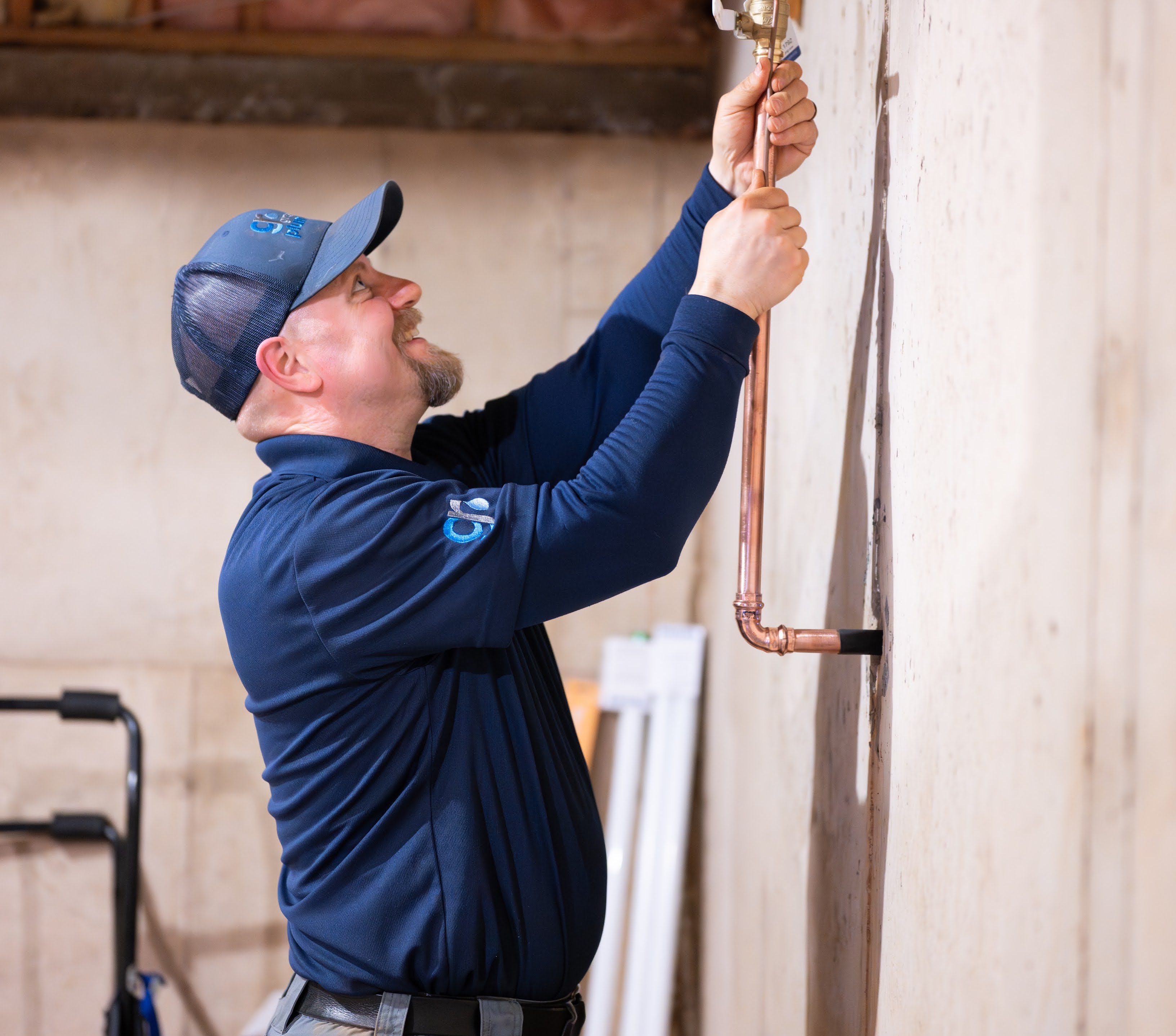 Plumber working on copper pipes