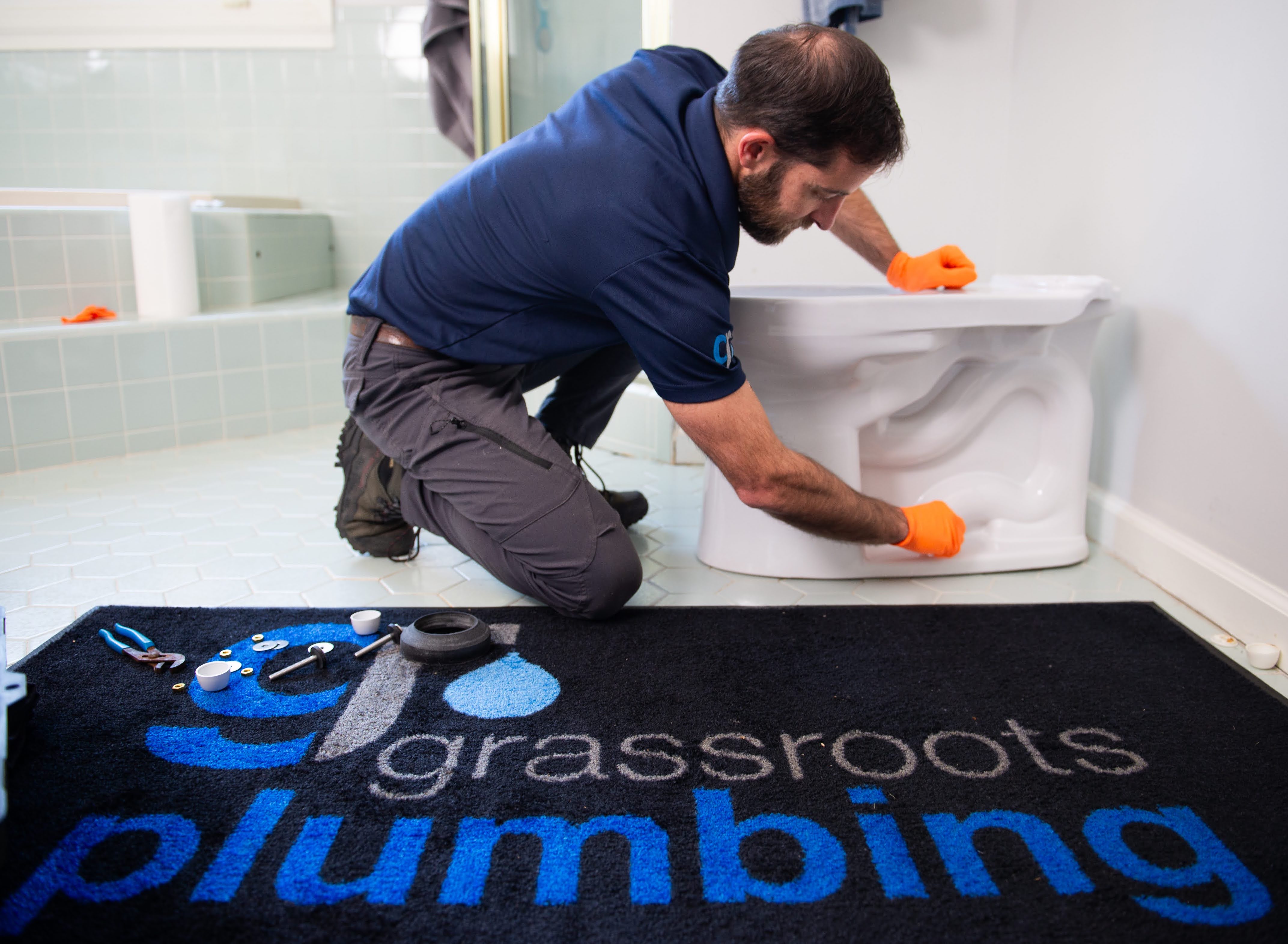 Plumber working on toilet