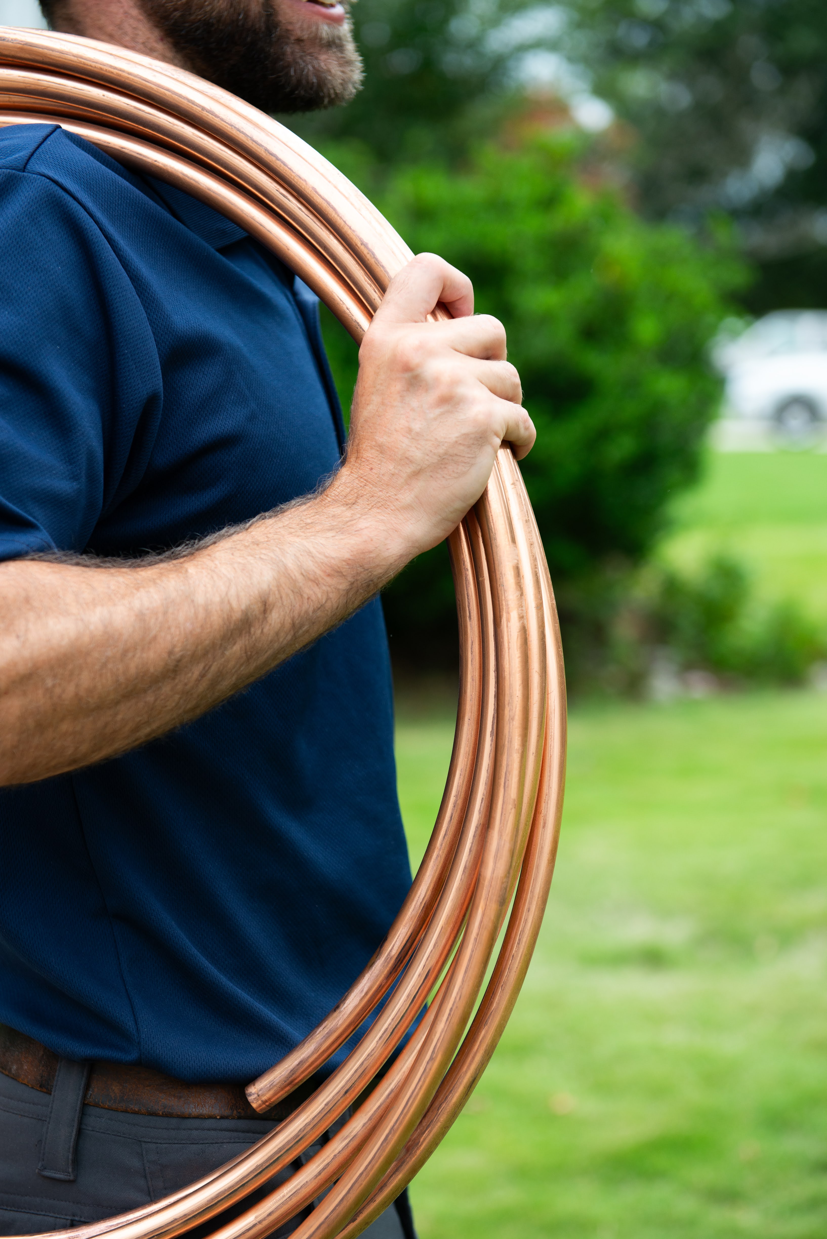 Hands holding copper pipe